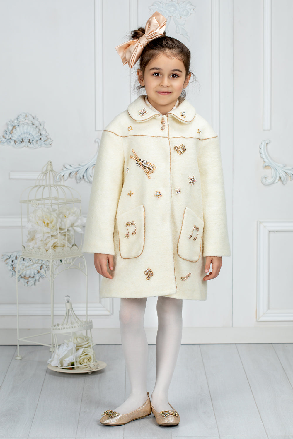 Ivory wool coat with handmade musical notes embellishments