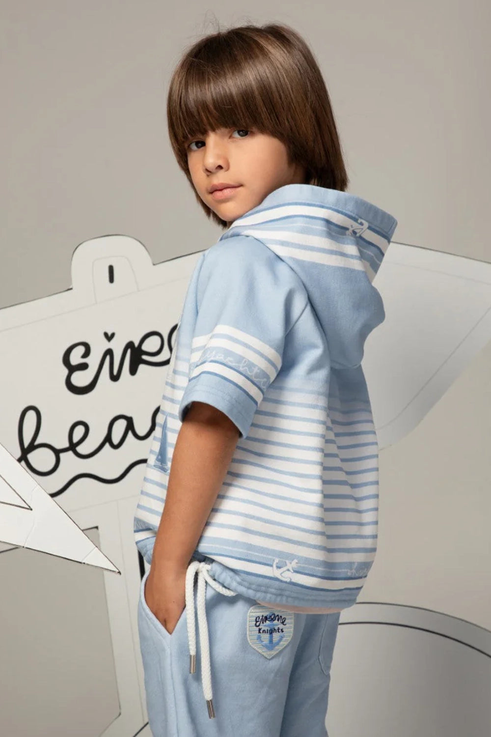 Light blue short-sleeved striped hoodie with sailboat print and Eirene Knights patch