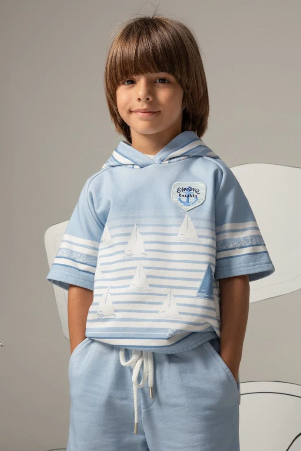 Light blue short-sleeved striped hoodie with sailboat print and Eirene Knights patch