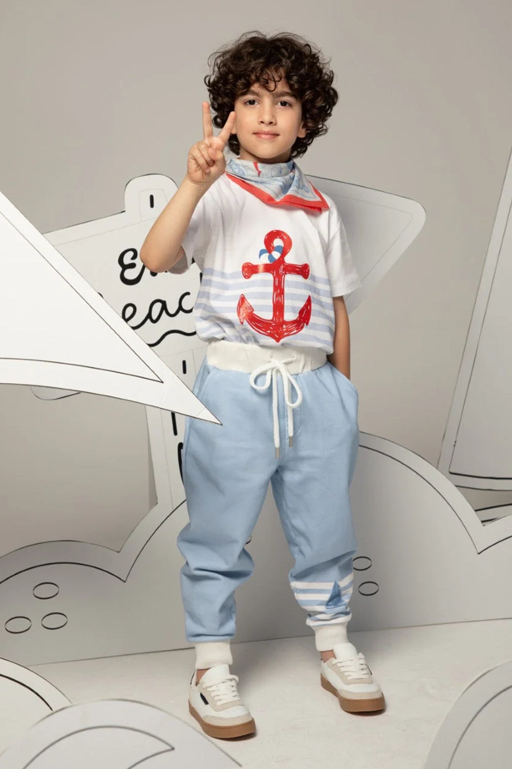 Light blue pants with white striped cuffs and a small sailboat print motif on the leg