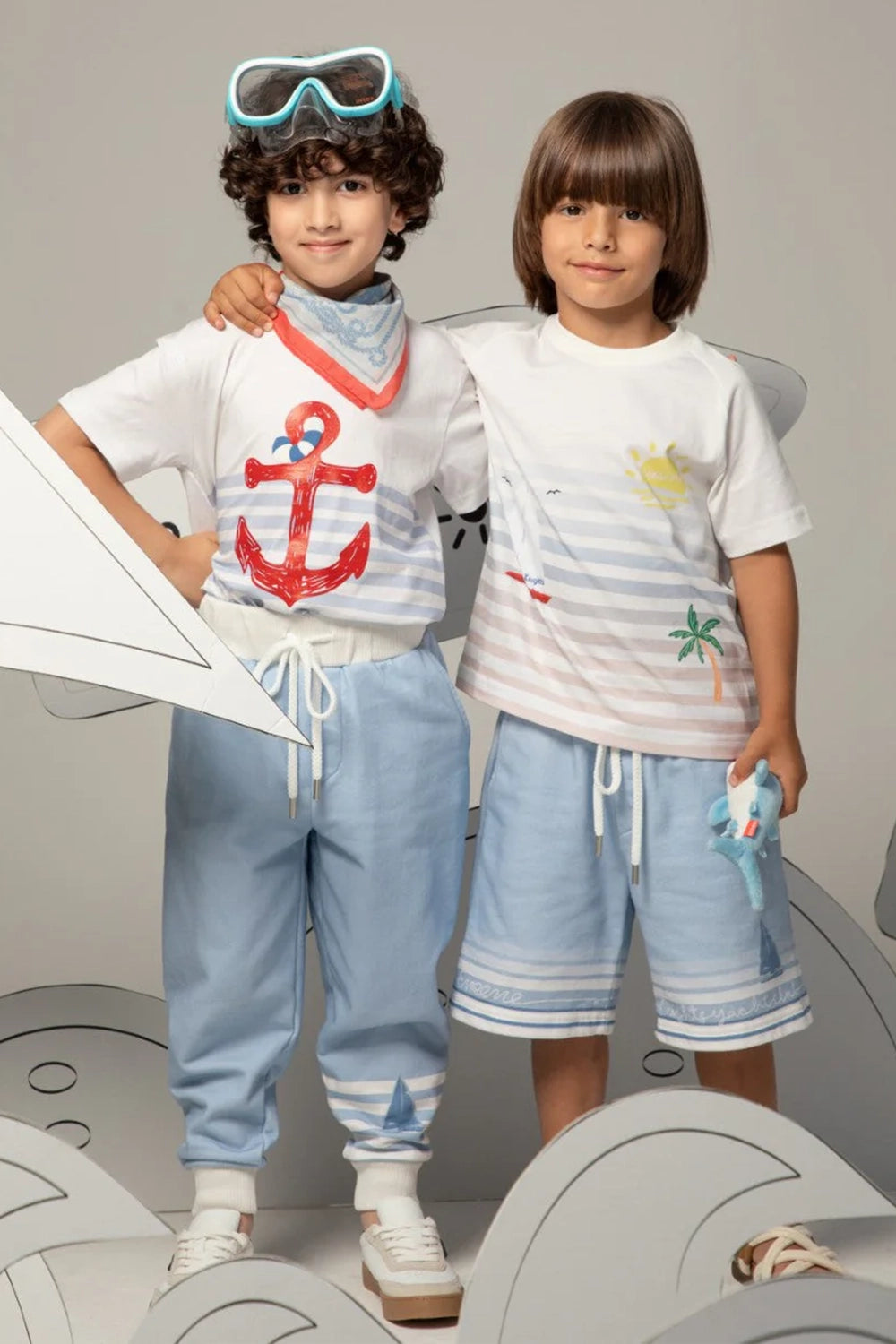 Light blue pants with white striped cuffs and a small sailboat print motif on the leg