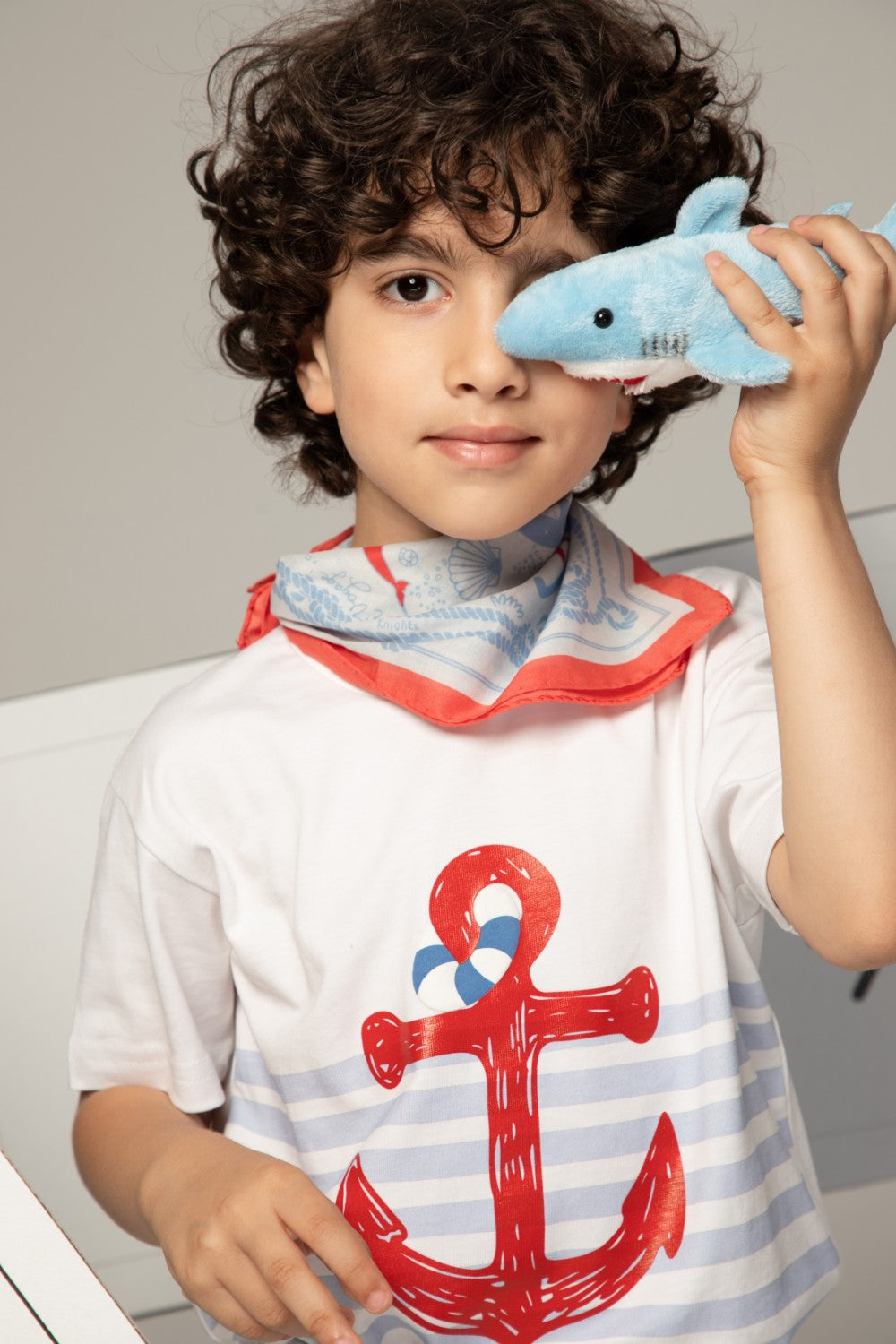 Light blue pants with white striped cuffs and a small sailboat print motif on the leg