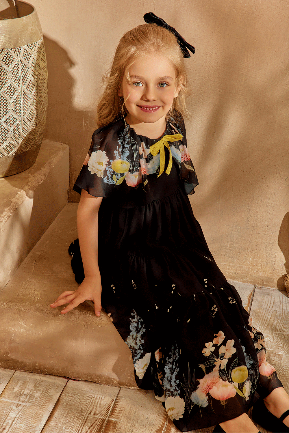 Black chiffon dress with floral cape and yellow bow detail