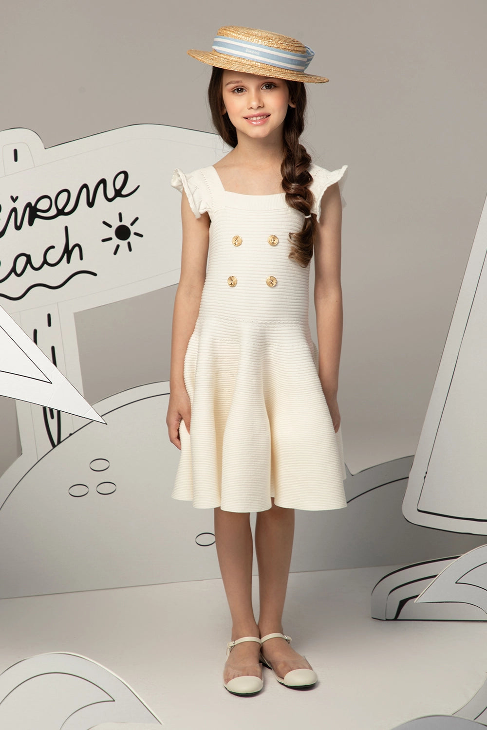 Ivory textured knit dress with flared skirt, gold anchor buttons and ruffled shoulder straps