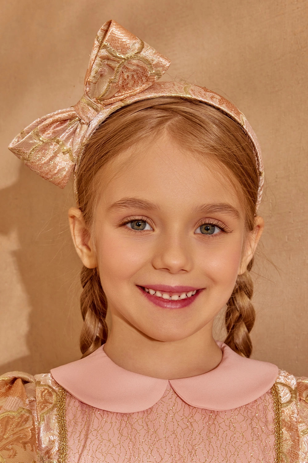 Padded brocade headband in soft gold-pink tones