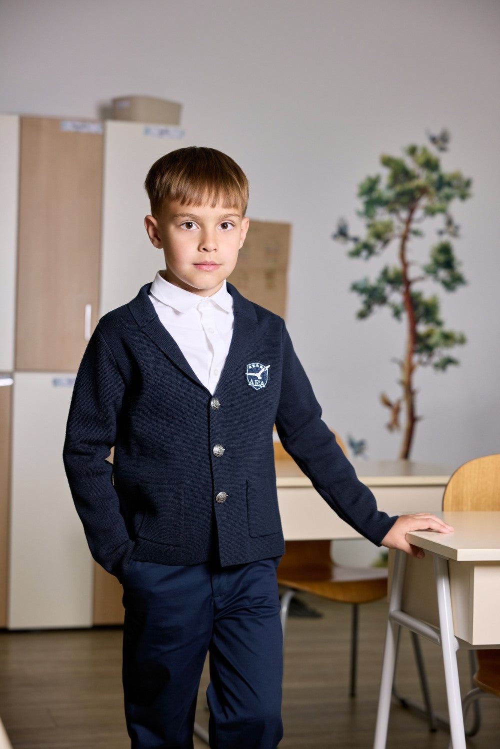 Navy cotton knit cardigan with crest badge and metal buttons