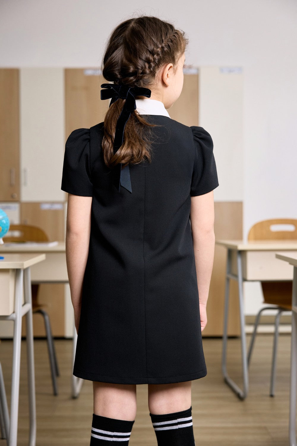Black dress with a white collar and ruched satin front