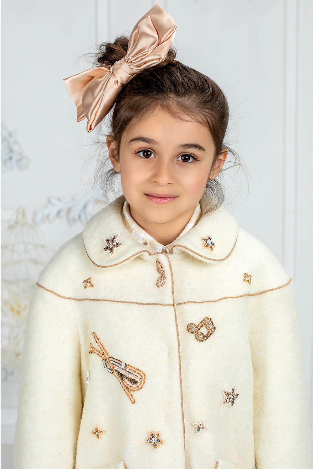 Ivory wool coat with handmade musical notes embellishments