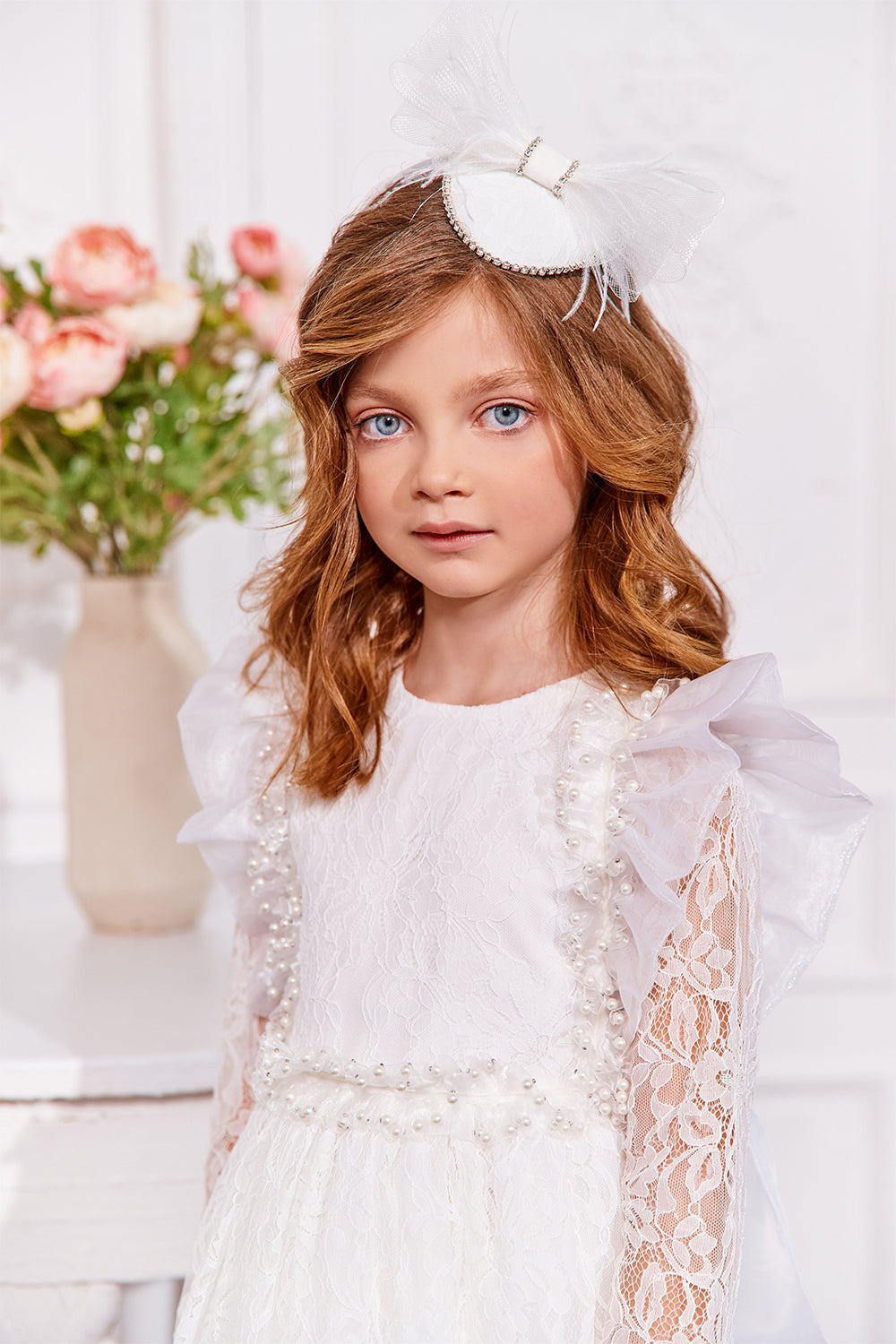 White lace dress with with pearls and organza bow and frills