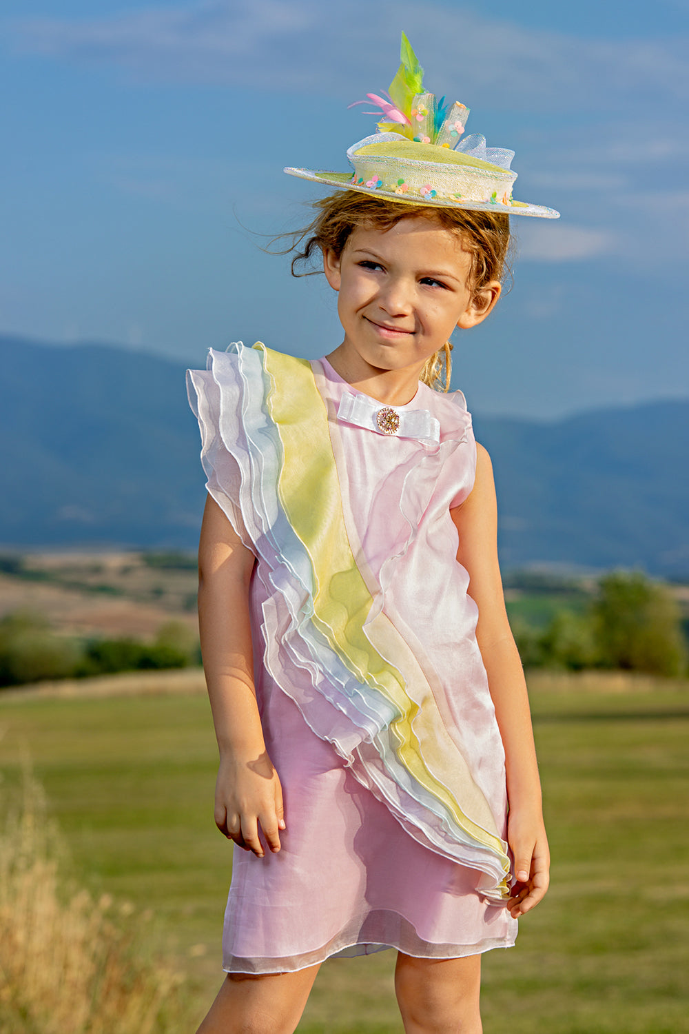 Pink silk organza dress with pastel silk frills and bow with Swarovski button