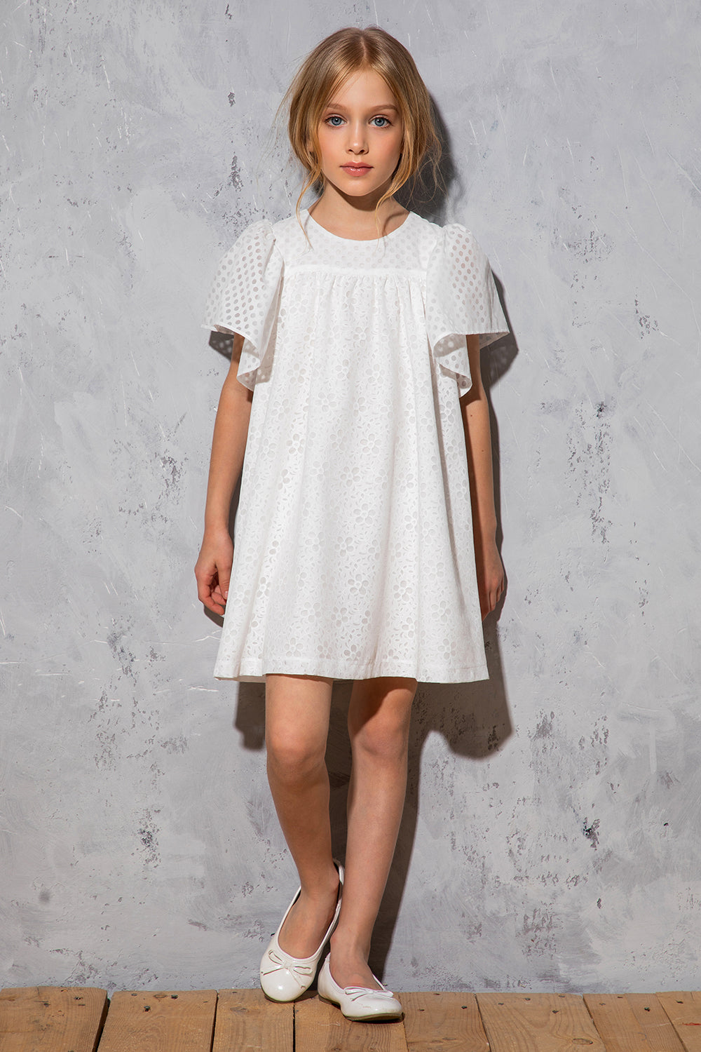 White flowy dress with dots and floral pattern with frilled sleeves