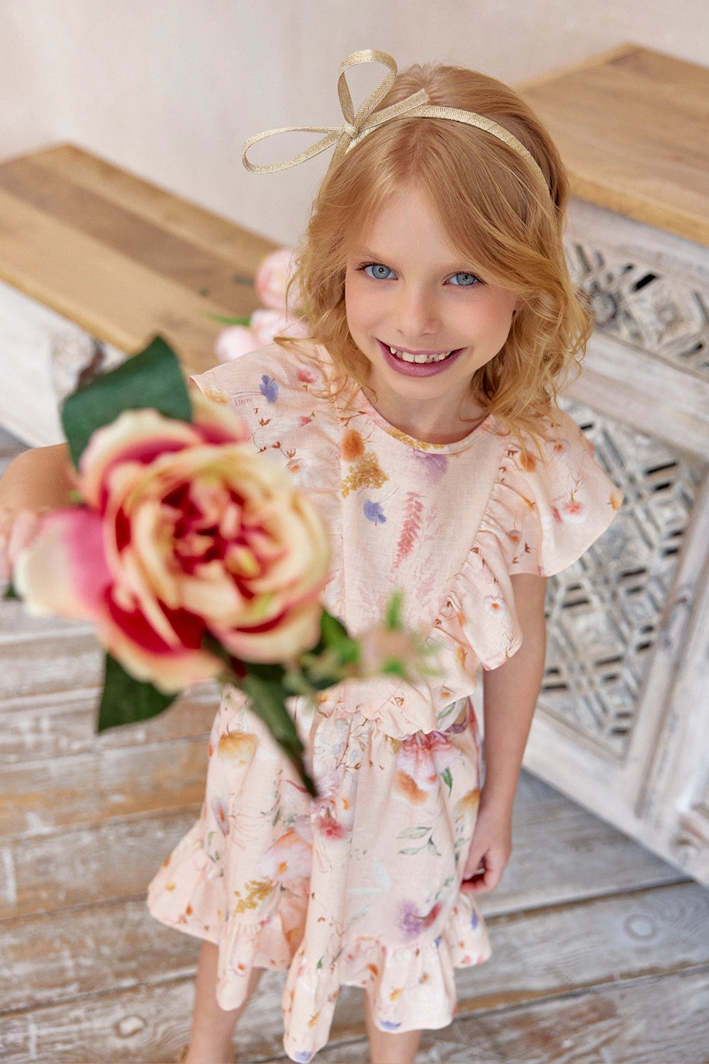 Floral linen dress with delicate side cutouts and soft pastel tones