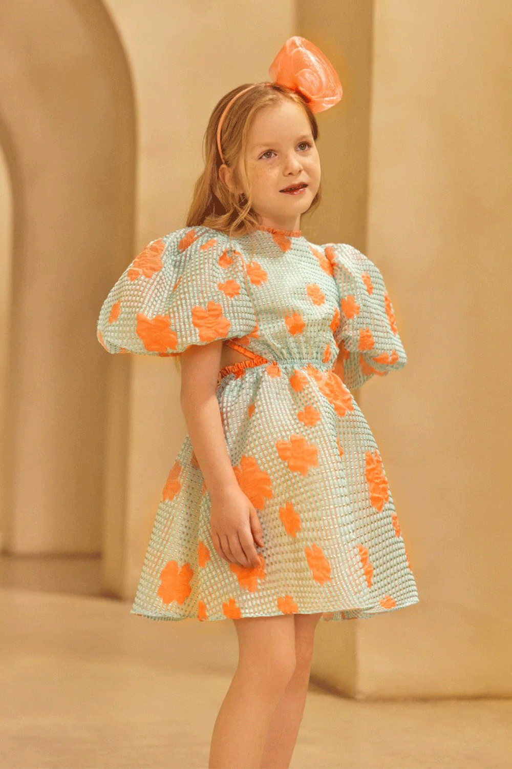 Aqua puff-sleeve jacquard organza dress with bold coral florals and a playful open-back detail