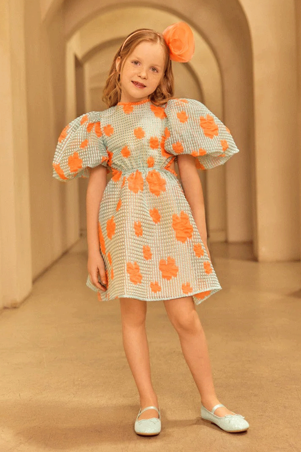 Aqua puff-sleeve jacquard organza dress with bold coral florals and a playful open-back detail