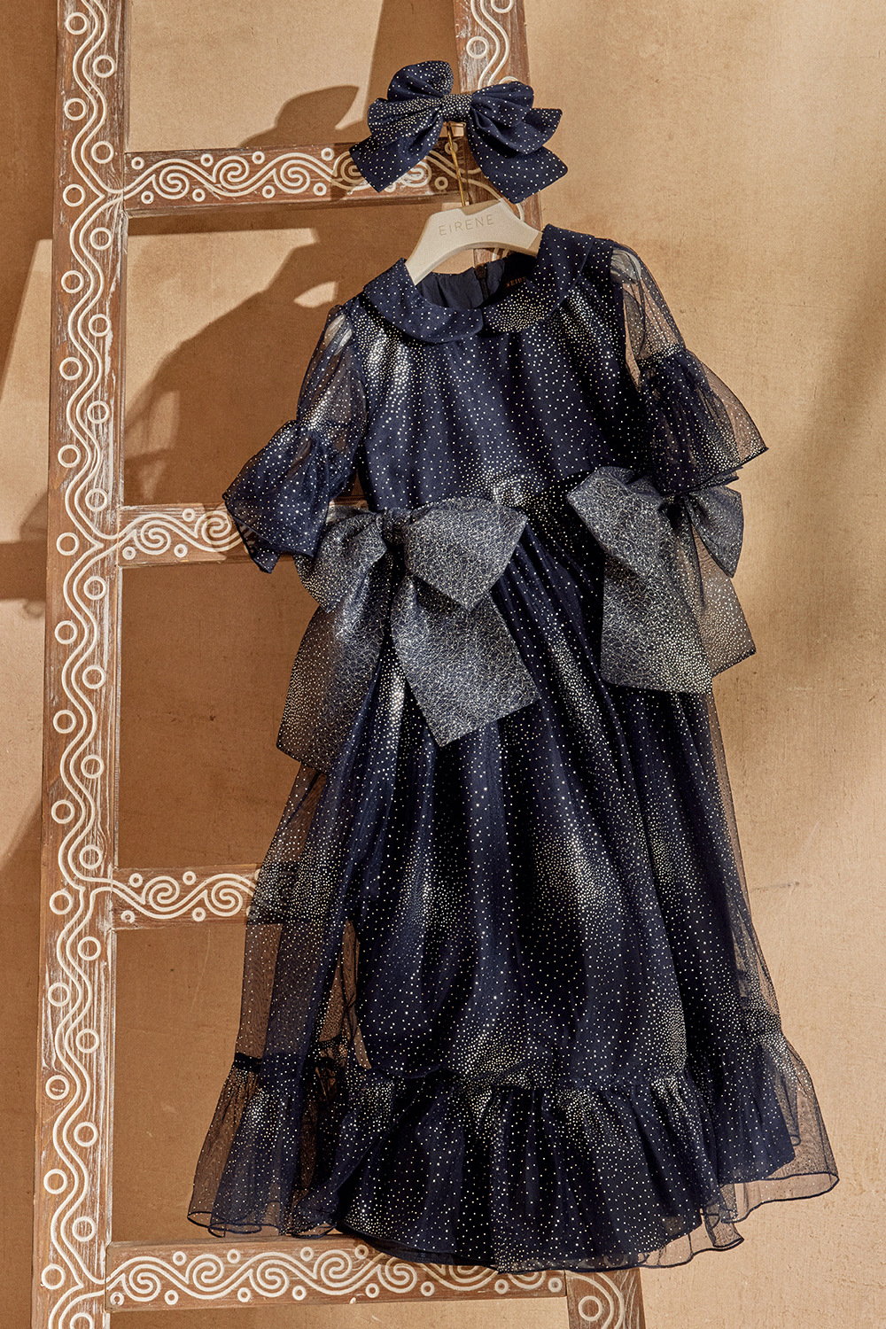Dark blue and silver dress with large bows and short sleeves