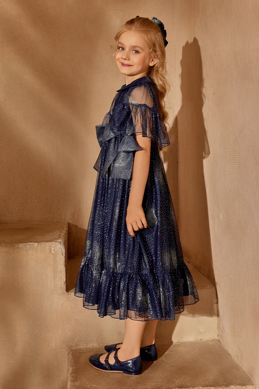 Dark blue and silver dress with large bows and short sleeves