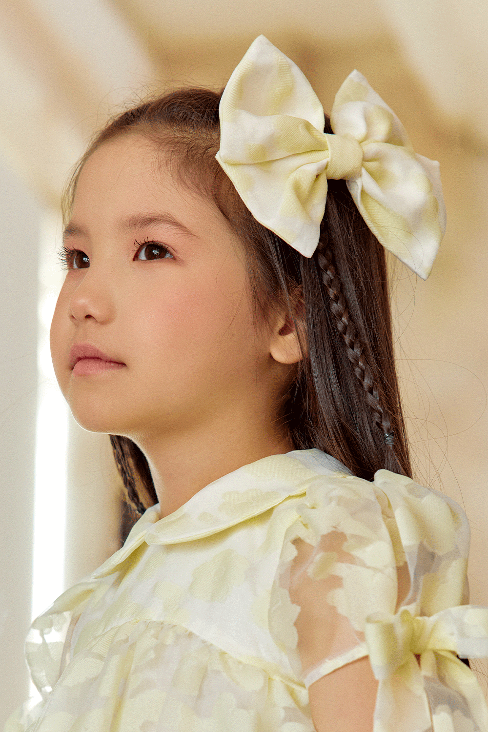 Oversized pale yellow bow hair clip in floral organza