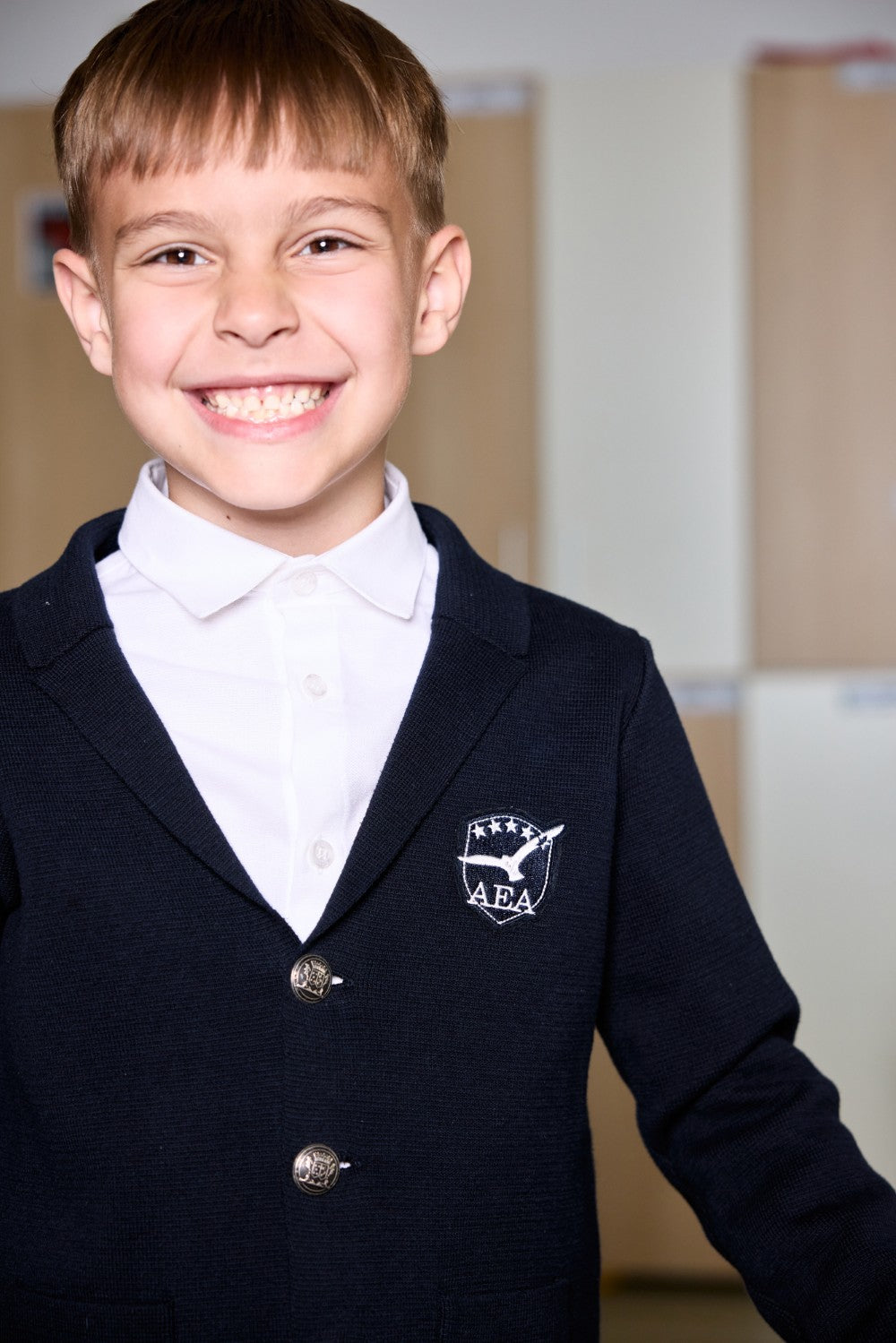 Navy cotton knit cardigan with crest badge and metal buttons