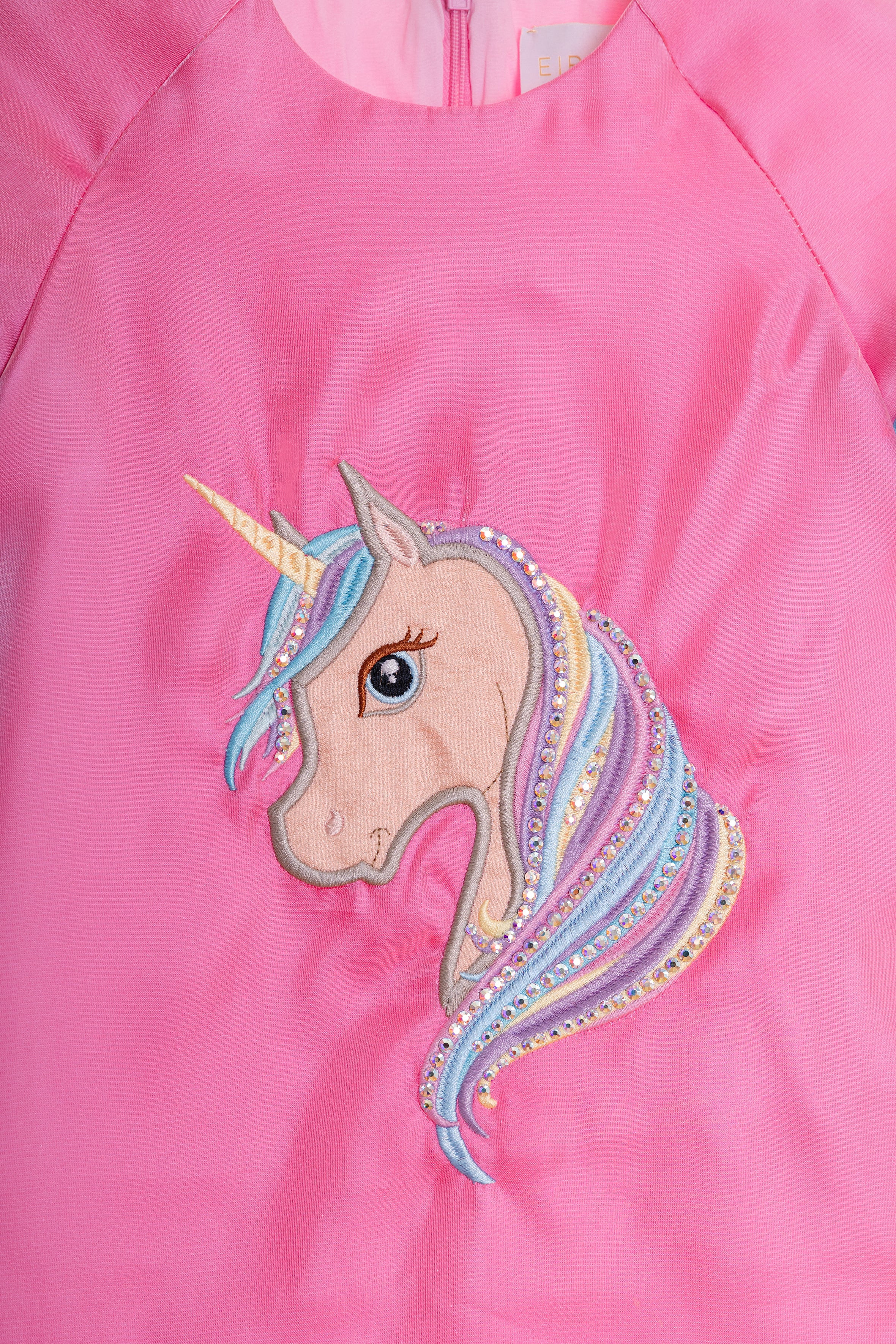 Fuchsia satin dress with unicorn embroidery, tulle frills and Swarovski crystals