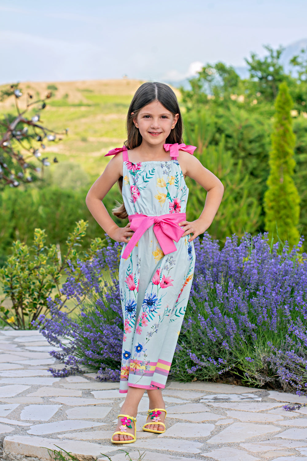 Light blue bright flowers satin cotton jumpsuit with fuchsia shoulder straps and belt